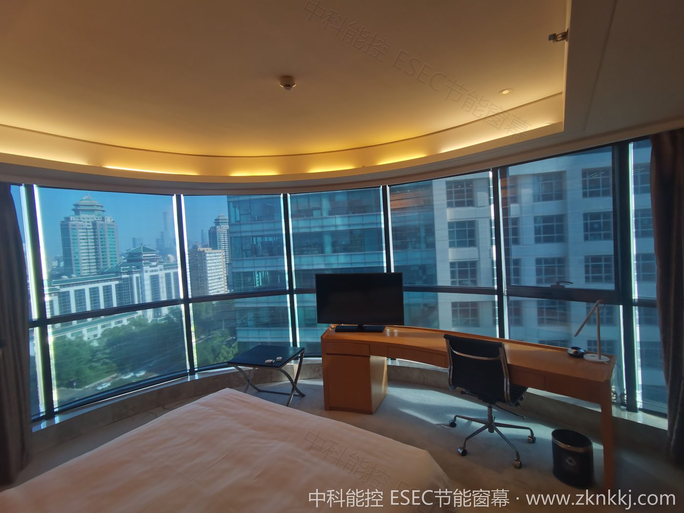 Hotel guest room before installation: bare windows with direct west-facing sun