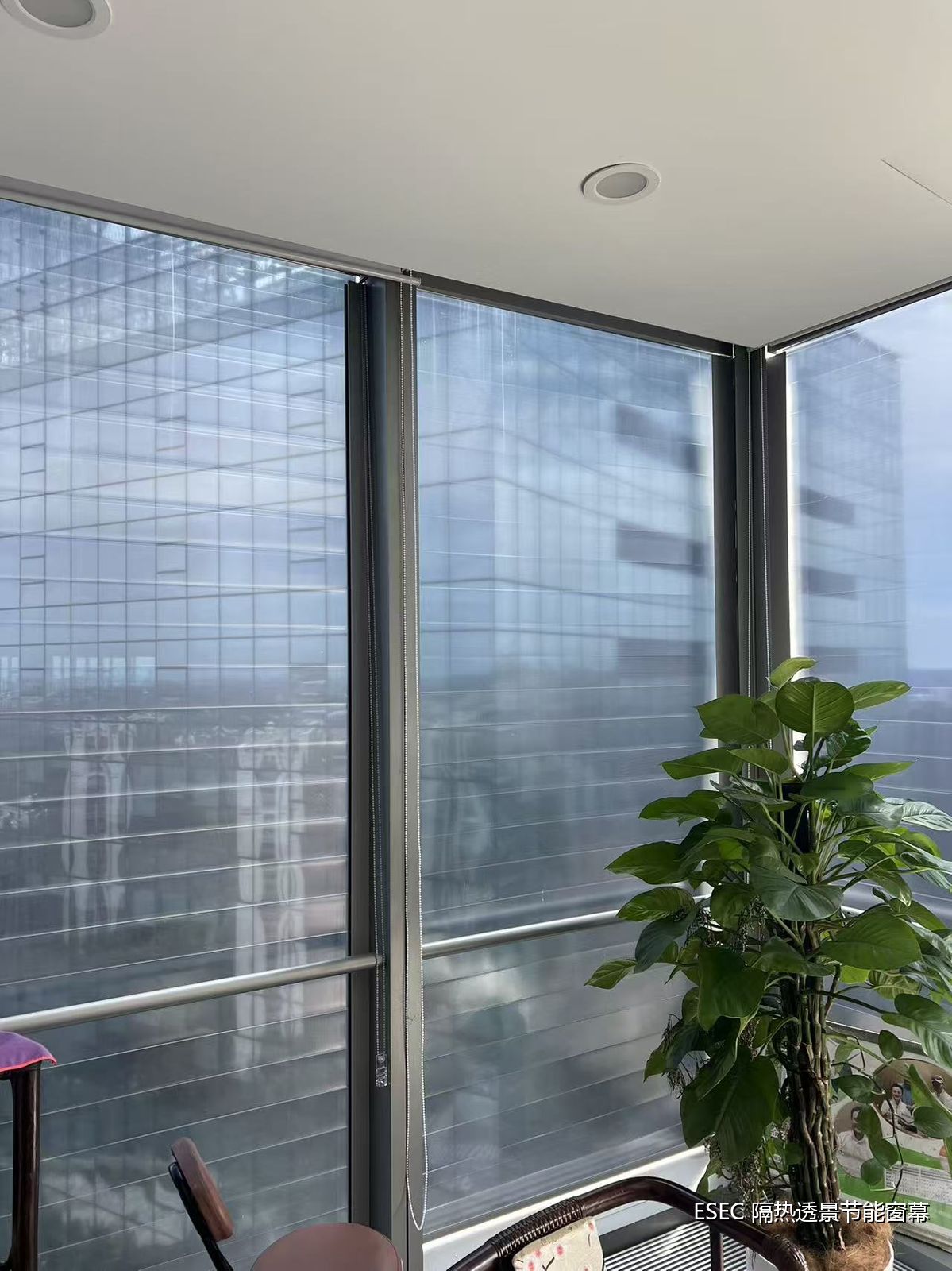 Window-side office area at POSCO Center after installation: soft light, clear view, no radiant heat